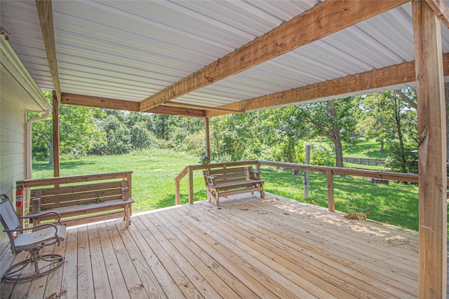 wooden terrace with a lawn