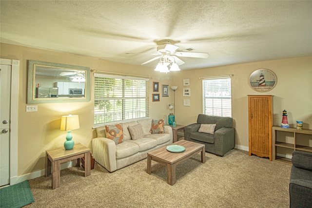 living room with a textured ceiling, a wealth of natural light, and light carpet