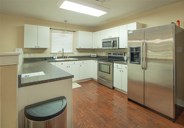 kitchen featuring appliances with stainless steel finishes, dark wood-type flooring, and white cabinetry