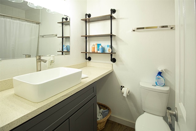 bathroom with hardwood / wood-style floors, vanity, and toilet