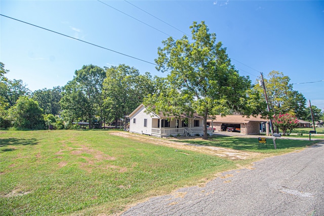 view of front facade with a front yard and covered porch