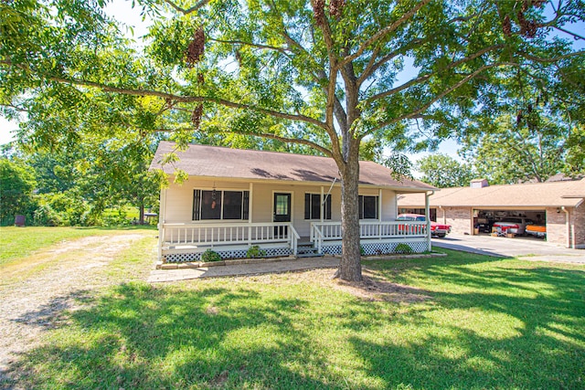 ranch-style home featuring a front lawn, a porch, and a carport