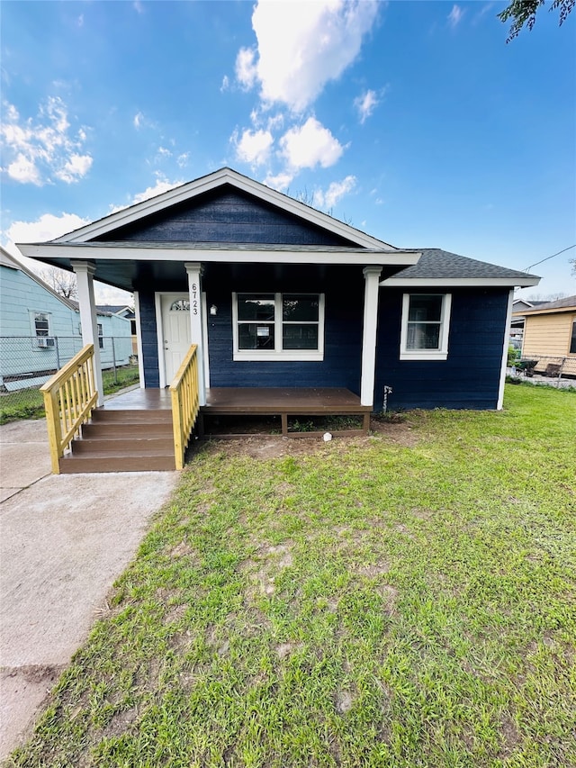 bungalow featuring a front lawn and covered porch