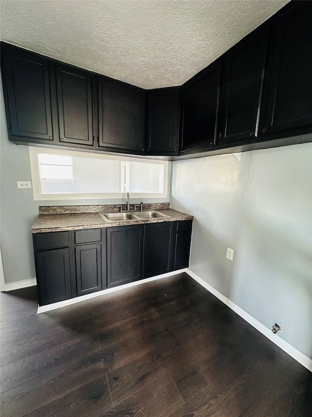 kitchen featuring dark hardwood / wood-style floors, a textured ceiling, and sink