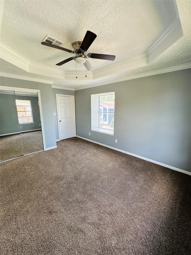 spare room with a healthy amount of sunlight, a tray ceiling, ceiling fan, and crown molding