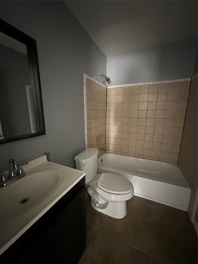 full bathroom with vanity, tiled shower / bath combo, and toilet