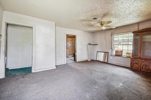 spare room featuring a textured ceiling and ceiling fan