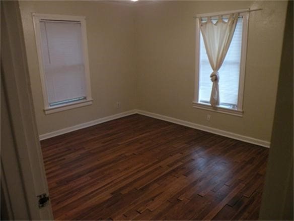 unfurnished room featuring dark hardwood / wood-style flooring