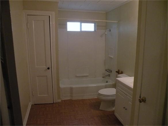 full bathroom featuring parquet flooring, toilet, washtub / shower combination, and vanity