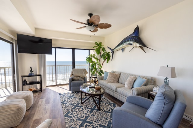 living room featuring a water view, dark hardwood / wood-style flooring, and ceiling fan