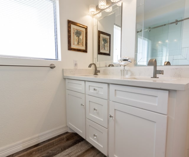 bathroom featuring dual vanity and hardwood / wood-style flooring