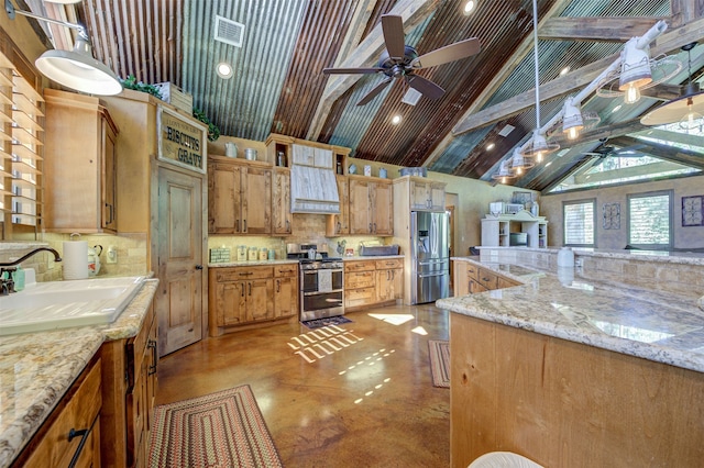 kitchen with light stone counters, ceiling fan, sink, and stainless steel appliances