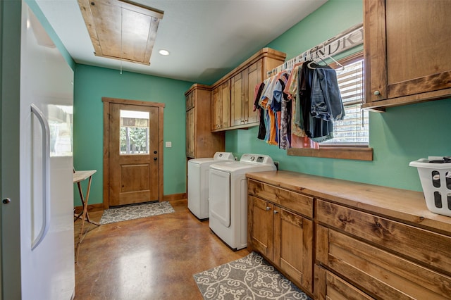 laundry area with washer and clothes dryer, cabinets, and a wealth of natural light