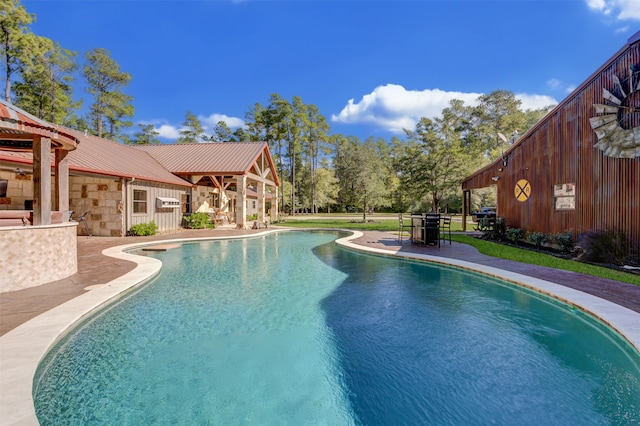 view of swimming pool with a patio