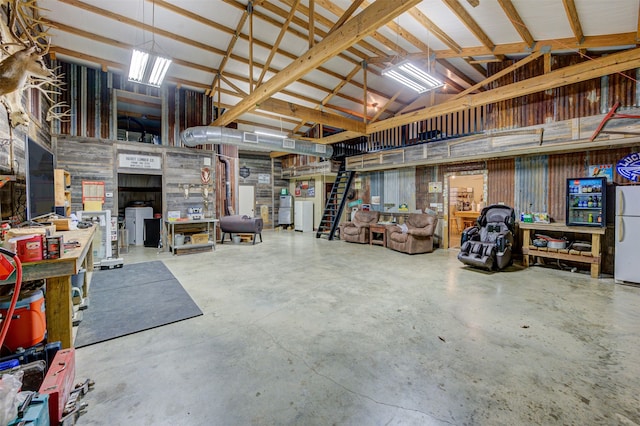 garage featuring a workshop area and white refrigerator