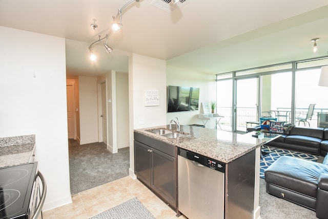 kitchen featuring stainless steel dishwasher, stove, rail lighting, light stone counters, and sink