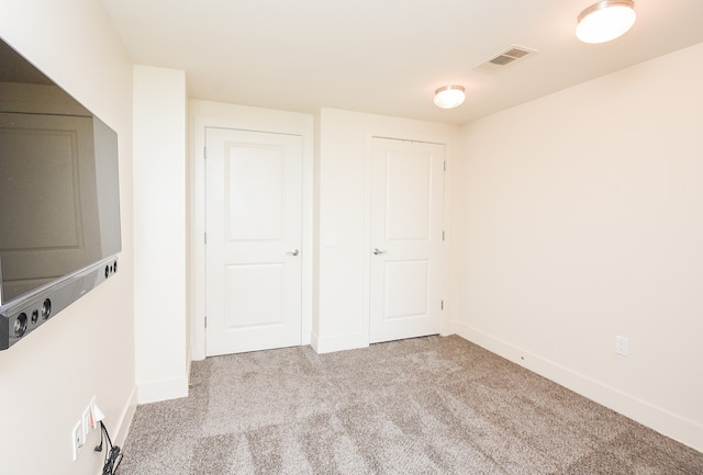 empty room with light colored carpet