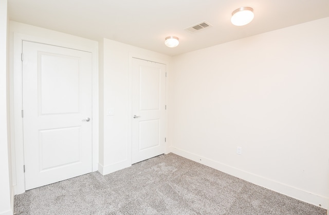 unfurnished bedroom featuring light colored carpet