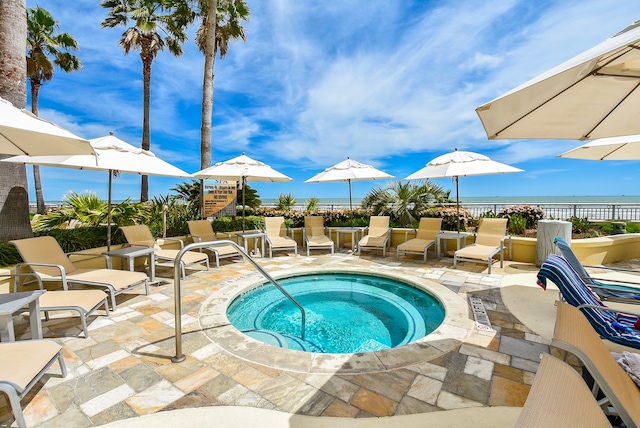 view of swimming pool featuring a community hot tub and a patio