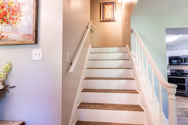 staircase featuring hardwood / wood-style floors