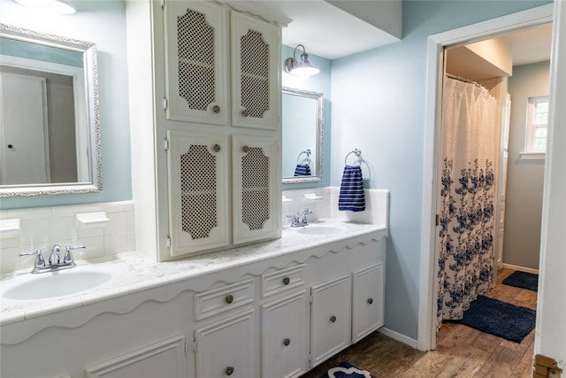 bathroom featuring backsplash, hardwood / wood-style flooring, and double vanity