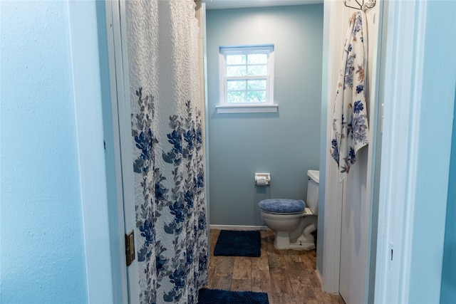 bathroom with toilet and wood-type flooring