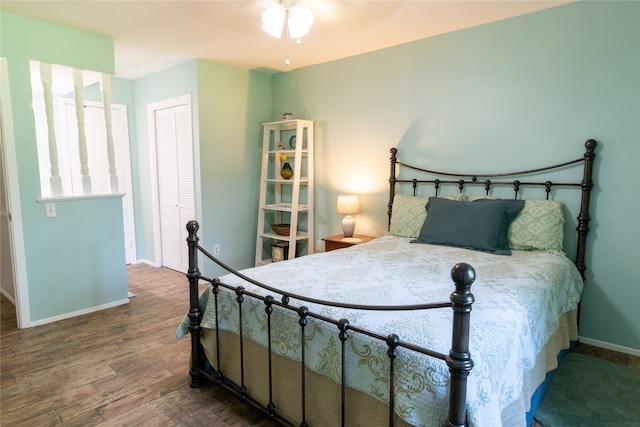 bedroom featuring ceiling fan, hardwood / wood-style flooring, and a closet