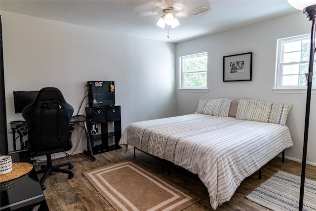 bedroom with ceiling fan and wood-type flooring