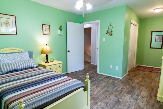 bedroom featuring dark hardwood / wood-style flooring and a closet