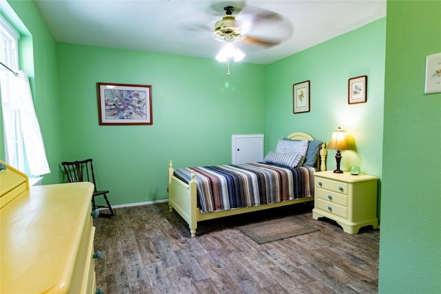 bedroom with dark hardwood / wood-style floors and ceiling fan