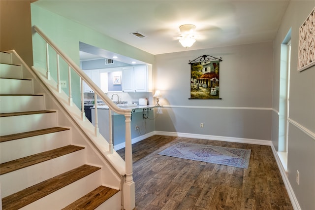 stairs featuring hardwood / wood-style floors