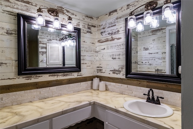 bathroom with tasteful backsplash and vanity