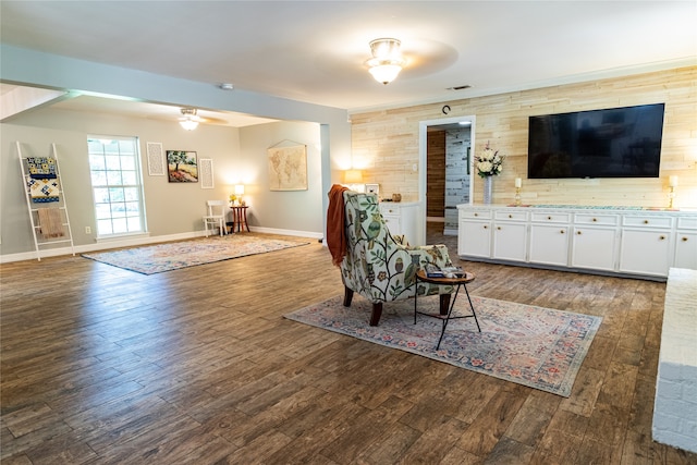 living room featuring wood-type flooring and ceiling fan