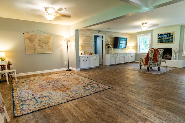 living area featuring hardwood / wood-style floors and ceiling fan