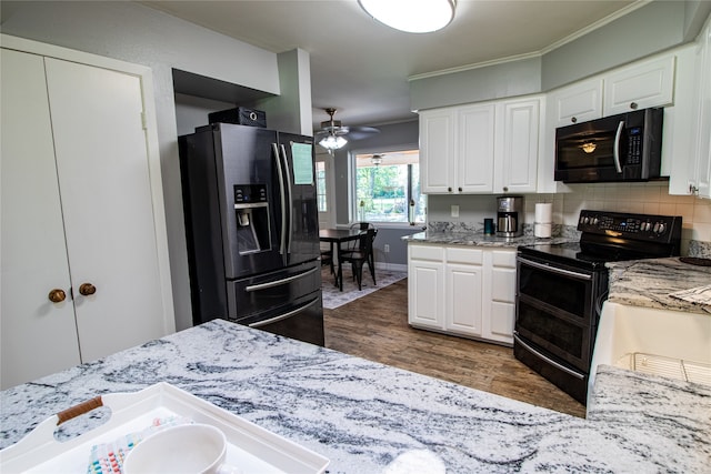 kitchen with dark hardwood / wood-style floors, ceiling fan, white cabinetry, black appliances, and tasteful backsplash