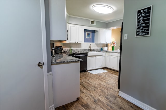 kitchen featuring black appliances, ornamental molding, hardwood / wood-style flooring, and white cabinetry