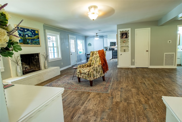 living room with a fireplace, hardwood / wood-style floors, and ceiling fan