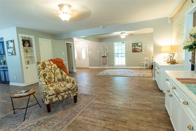 interior space with ceiling fan and dark hardwood / wood-style flooring