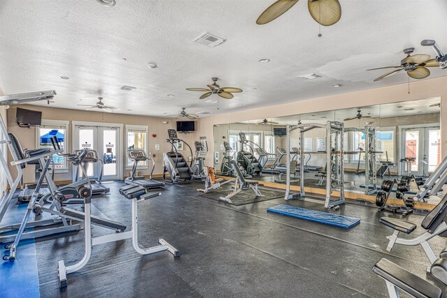 exercise room featuring french doors, a textured ceiling, and ceiling fan