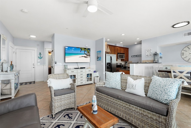 tiled living room featuring ceiling fan