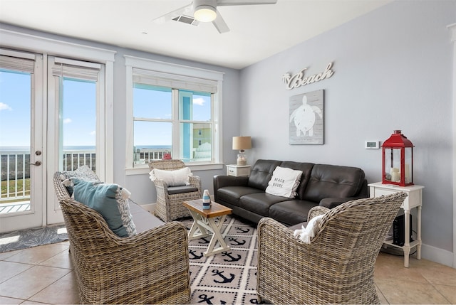 living room featuring ceiling fan and light tile floors