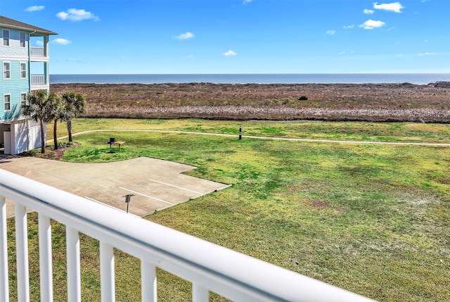 view of yard with a water view and a balcony