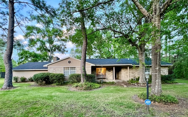 ranch-style house featuring a porch and a front lawn