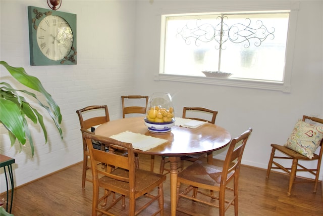 dining room featuring hardwood / wood-style floors and a healthy amount of sunlight