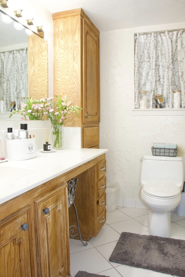 bathroom featuring vanity, tile floors, and toilet