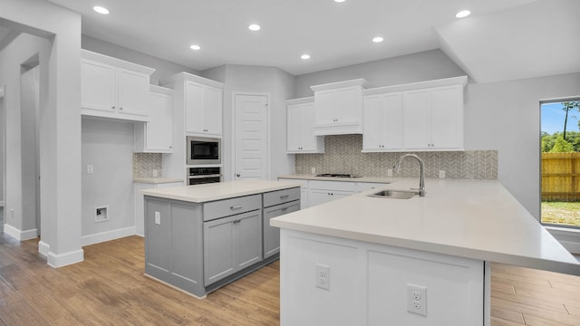 kitchen with tasteful backsplash, stainless steel appliances, and white cabinets