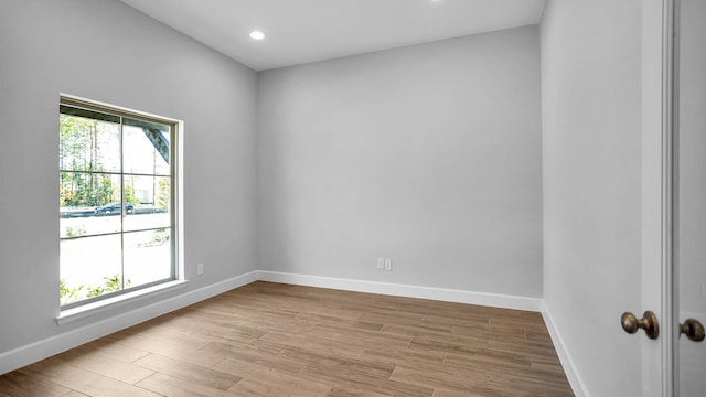 unfurnished room with plenty of natural light and light hardwood / wood-style flooring