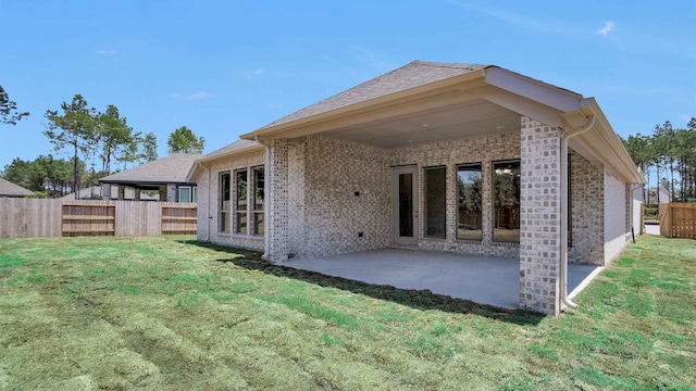 back of property featuring a yard and a patio