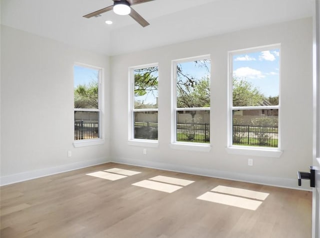 spare room featuring light wood-type flooring and plenty of natural light