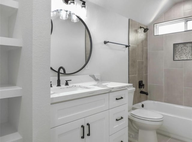 full bathroom featuring vanity, tiled shower / bath combo, vaulted ceiling, and toilet